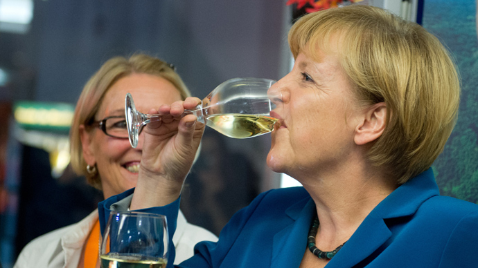 German Chancellor Angela Merkel drinks a glass of vine during the election party of her Christian Democratic Union (CDU) party at the party's headquarters in Berlin on September 22, 2013 (AFP Photo)