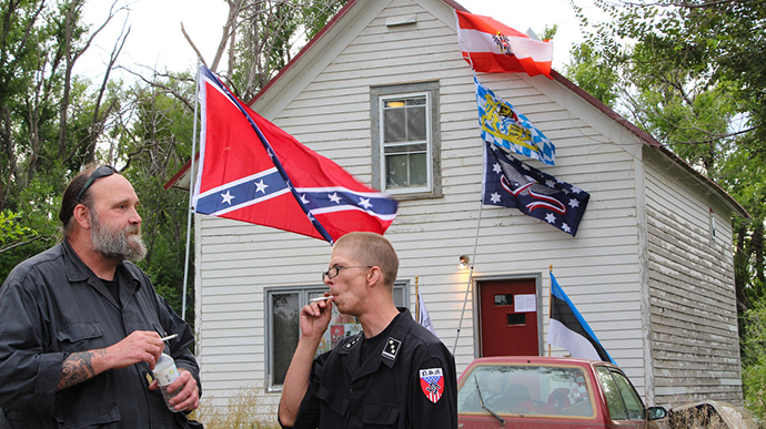 Members of NMS stand outside the home of white supremacist, Craig Cobb, who began buying up land in Leith, North Dakota to create an all-white settlement. (Image from flickr.com user@uneditedmedia)