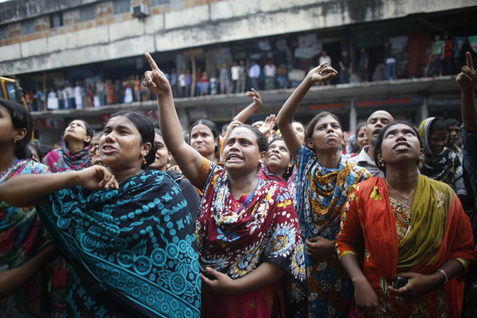 Garment workers shout as they call other workers to join them, in front of Brothers Fashion Limited, during a protest in Dhaka September 23, 2013. (Reuters/Andrew Biraj)