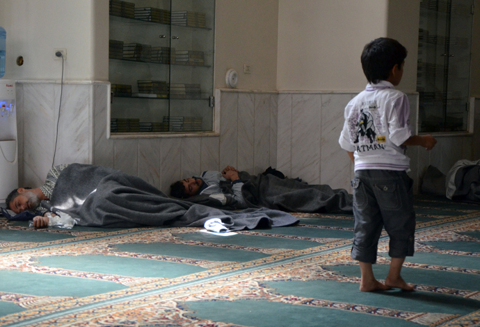 Survivors from what activists say is a gas attack rest inside a mosque in the Duma neighbourhood of Damascus August 21, 2013 (Reuters / Bassam Khabieh)