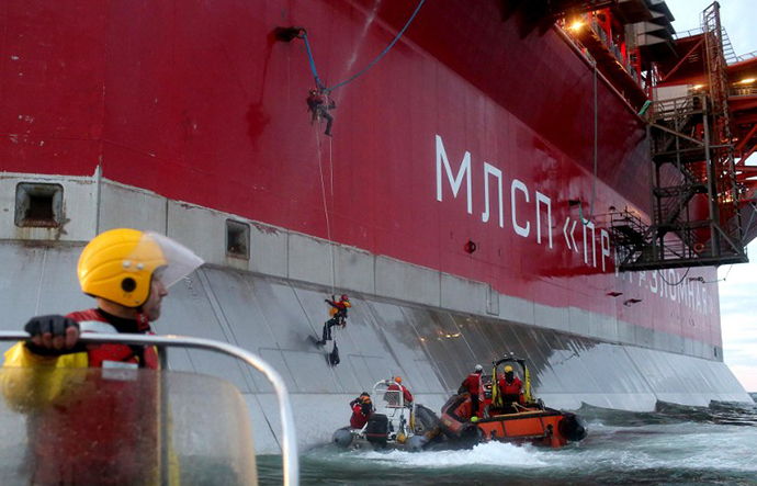 A handout photo taken by Greenpeace on September 18, 2013, shows Greenpeace activists boarding Gazprom's 'Prirazlomnaya' Arctic oil platform somewhere off Russia north-eastern coast in the Pechora Sea. (AFP Photo / Denis Sinyakov)