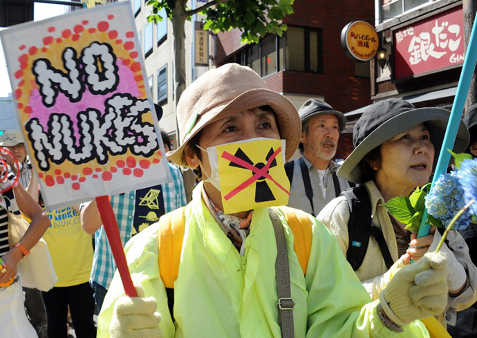 Protesters hold banners during a protest rally against nuclear power plants, following the March 2011 Fukushima meltdown-disasters, in Tokyo on June 2, 2013. (AFP Photo / Rie Ishii)