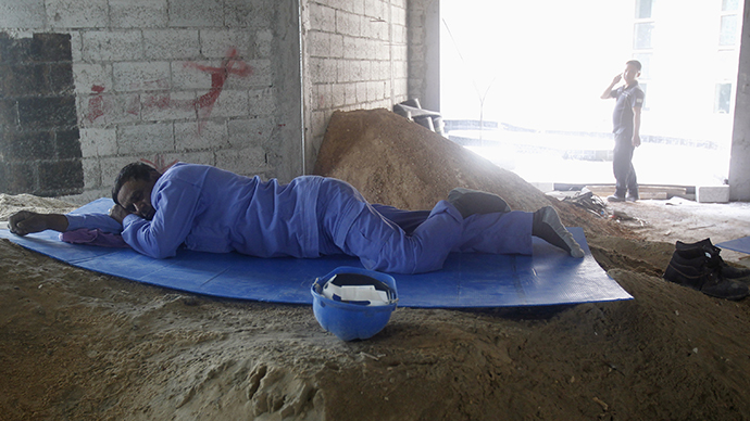 A construction worker rests during his lunch break in Doha (Reuters)