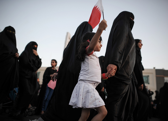 A Bahraini girl holds up her national flag as she takes part in an anti-government protest in the village of Jannusan, west of the capital Manama, on September 27, 2013 (AFP Photo / Mohammed Al-Shaikh) 