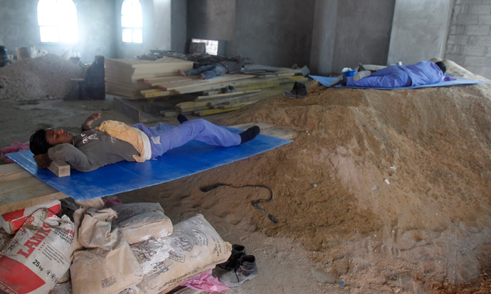 Construction workers rest during their lunch break in Doha, Qatar (Reuters / Stringer)