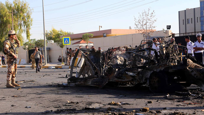 Iraqi Kurdish security forces gather at the site of a car bomb explosion in Arbil, the capital of Iraqâs autonomous Kurdistan Region, on September 29, 2013. Militants killed six people, officials said, in a rare attack on an area usually spared violence plaguing the country.(AFP Photo / Safin Hamed)