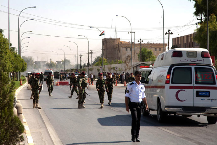Iraqi Kurdish security forces and medical services are seen at the site of an explosion in Arbil, outside the headquarters of the Kurdish aayesh security services in the capital of Iraqâs autonomous Kurdistan region, on September 29, 2013. (AFP Photo / Safin Hamed)
