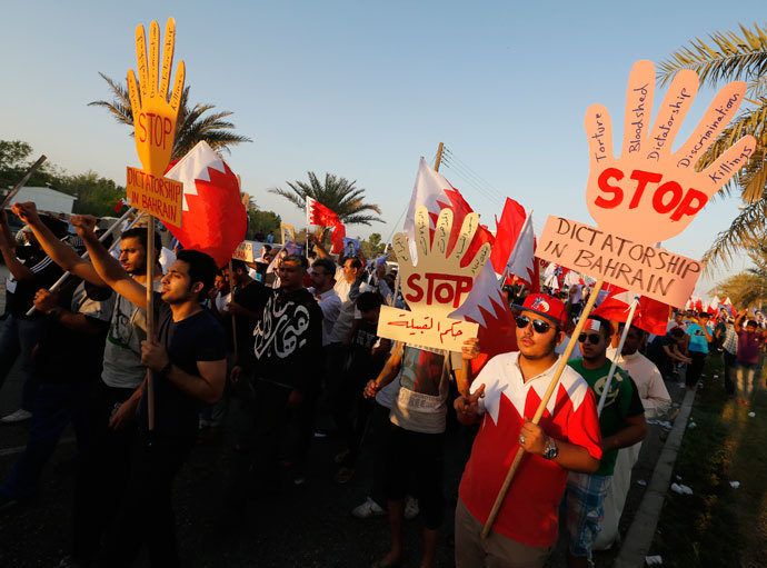 Anti-government protesters holding banners saying "Stop Dictatorship In Bahrain" as they participate in a rally called by Bahrain's main opposition Al Wefaq in Budaiya, west of Manama, September 27, 2013.(Reuters / Hamad I Mohammed)