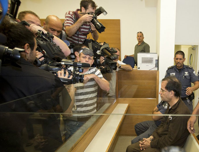 Ali Mansouri, 58, arrested at Ben Gurion Airport on suspicion of espionage, is photographed as he sits at the Petah Tikva District Court on the first day of their trial on September 30, 2013. (AFP Photo / Jack Guez)