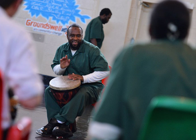 Rikers Island inmate Salideen Ali takes part in a drum performance as The National Association Of Music Merchants (NAMM) NAMM Presents First Ever National Music Day And Make Music NY at Rikers Island on June 21, 2013 in New York City. (AFP Photo / Stephen Lovekin)