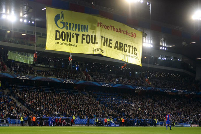 Greenpeace activists (top) hold a demonstration during the UEFA Champions League group E football match between Switzerland's Basel and Schalke of Germany on October 1, 2013 at the St. Jakob-Park Stadium in Basel. (AFP Photo / Fabrice Coffrini)