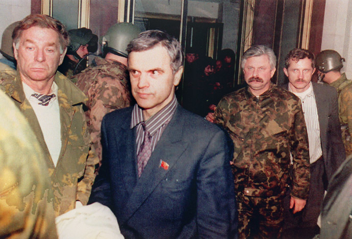 Former Soviet Parliament Chairman Ruslan Khasbulatov (2nd-L) and former Parliament Vice-President Alexander Rutskoi (3rd-R) are guarded by members of "Team Alpha" special forces after being arrested 04 October 1993 inside of Parliament "White House" building during the coup d'etat as the anti-Yeltsin rebellion goes on. (AFP Photo/Dima Tanin)