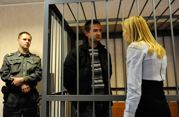 Ruslan Yakushev of Ukraine stands inside a defendants' box at a district court in Murmansk September 29, 2013.(Reuters / Sergei Eshchenko)