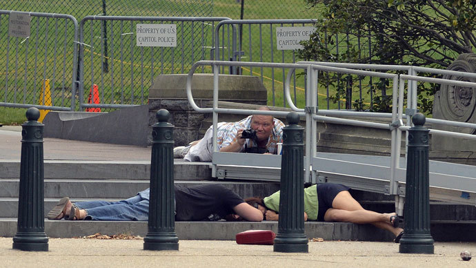 People take cover as gun shots were being heard at the US Capitol in Washington, DC, on October 3, 2013. (AFP Photo / Jewel Samad)