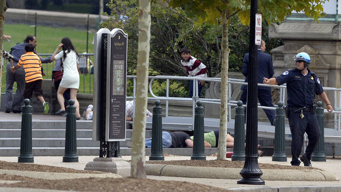 People take cover as gun shoot being heard at the Capitol in Washington, DC, on October 3, 2013.(AFP Photo / Jewel Samad)