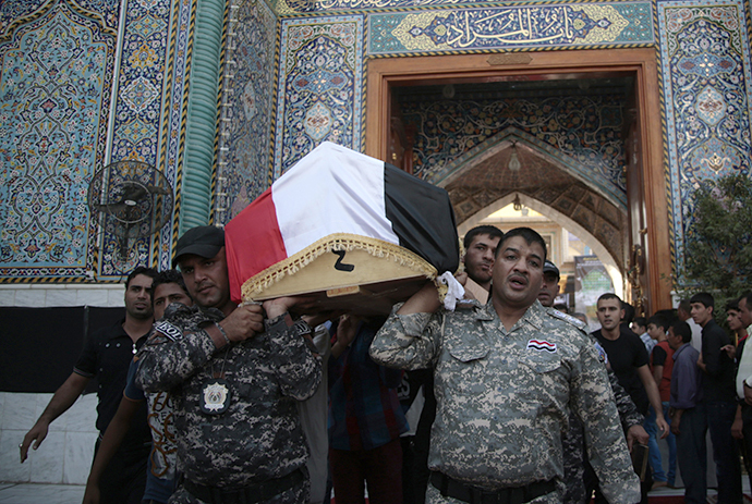 Mourners carry the coffin of a victim was killed by suicide bombers during a funeral at holy city of Kadhimiya in Baghdad October 6, 2013. (Reuters / Ahmad Mousa)