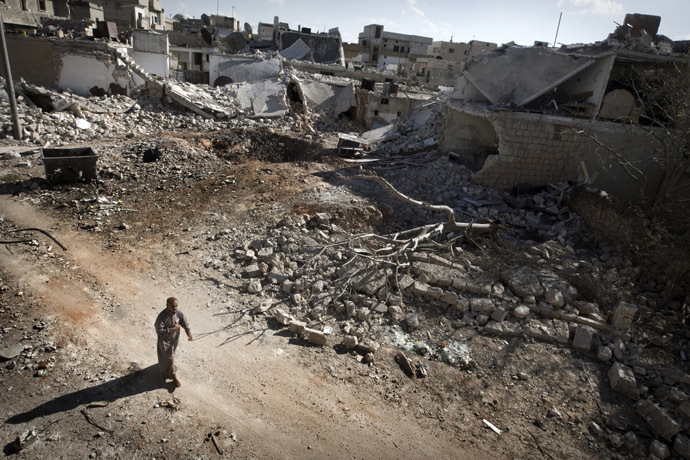 A man walks through a destroyed residential area of the Syrian city of Saraqib, southwest of Aleppo, on September 9, 2013 (AFP Photo)