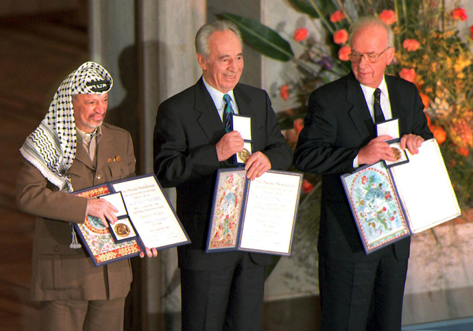 A picture dated 10 December 1994 of (from left) Palestinian leader Yasser Arafat, then Israeli Foreign Minister Shimon Peres, and late Israeli Prime Minister Yitzhak Rabin as they pose with the Nobel Peace Prize, which they were awarded in the Oslo City Hall (AFP Photo)
