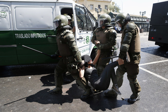 A student protester is detained by riot policemen during a demonstration against the government to demand changes in the public state education system in Santiago, October 17, 2013. (Reuters//Ivan Alvarado)