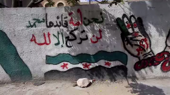Free Syrian Army graffiti on the wall in the town of Yabroud. (RT video still)