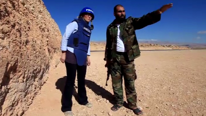 RTâs Maria Finoshina (L) interviews Free Syrian Army Fighter, Abu al Hasan, outside the village of Maaloula. (Still from RT video)