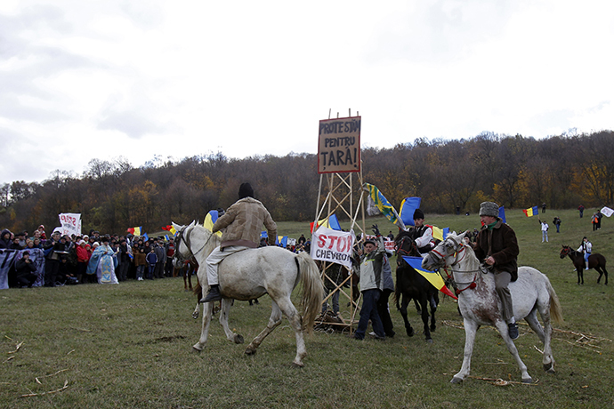 Men ride horses around a makeshift well during a protest against plans by U.S. oil major Chevron to search for shale gas in Pungesti, 340 km (211 miles) northeast of Bucharest October 19, 2013. (Reuters / Bogdan Cristel)