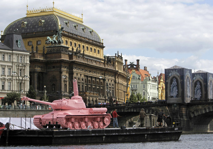 A Soviet WW II tank painted pink is located on a boat in front of the National Theatre in Prague June 20, 2011. (Reuters/David W Cerny)