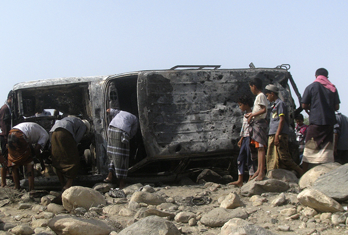 People gather at the site of a drone strike on the road between Yafe and Radfan districts of the southern Yemeni province of Lahj August 11, 2013. (Reuters)