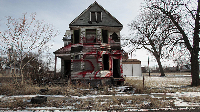 A vacant and blighted home, covered with red spray paint, sits alone in an east side neighborhood once full of homes in Detroit (Reuters / Rebecca Cook)