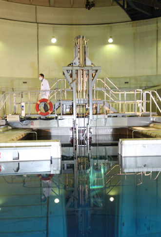 Metal-encased rod with 20 percent enriched nuclear fuel as it is inserted into Tehran's reactor (AFP Photo)