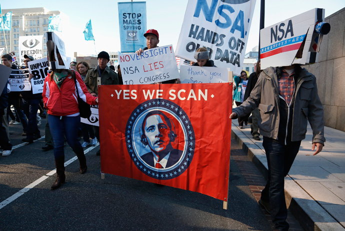 Demonstrators wearing cardboard surveillance camera hats carry a sign depicting U.S. President Barack Obama at the "Stop Watching Us: A Rally Against Mass Surveillance" march in Washington, October 26, 2013. (Reuters / Jonathan Ernst) 