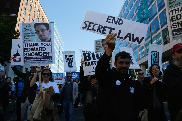 Demonstarators carry signs at the "Stop Watching Us: A Rally Against Mass Surveillance" march near the U.S. Capitol in Washington, October 26, 2013. (Reuters / Jonathan Ernst) 