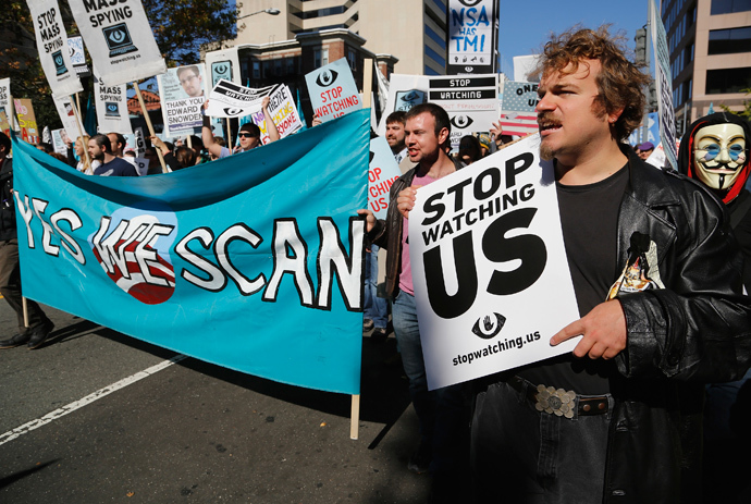 Demonstarators carry signs at the "Stop Watching Us: A Rally Against Mass Surveillance" march near the U.S. Capitol in Washington, October 26, 2013. (Reuters / Jonathan Ernst) 