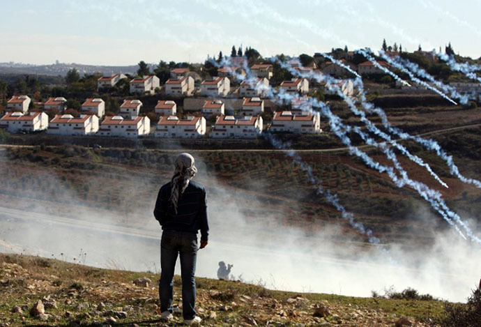 Israeli soldiers fire tear gas at Palestinian protesters during a weekly demonstration against the construction and expansion of settlements on village lands in the West Bank village of Nabi Saleh, near Ramallah (AFP Photo / Abbas Momani)
