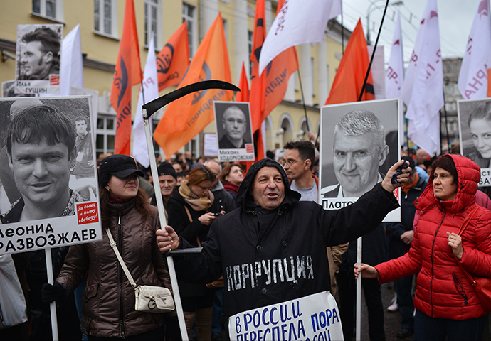 A protestor holds a scythe during an opposition rally in central Moscow on October 27, 2013. (RIA Novosti / Ramil Sitdikov)