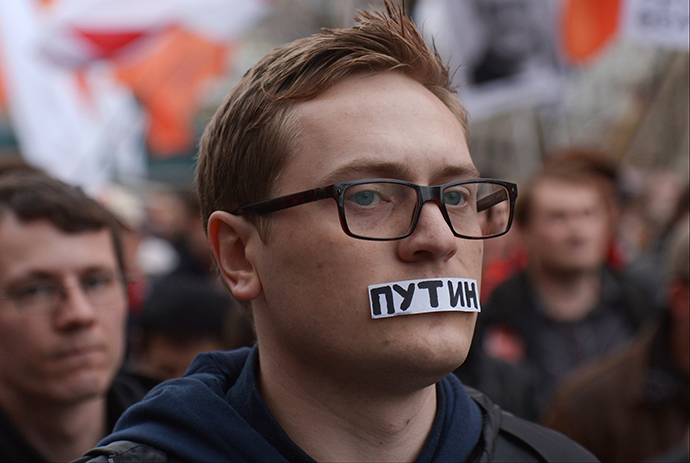 A demonstrator wears a tape over his mouth reading Putin during an opposition rally in central Moscow on October 27, 2013. (RIA Novosti / Evgeny Biyatov)