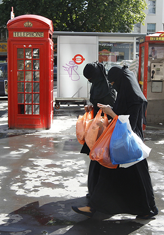 Women wears full-face veils as they shop in London (Reuters / Luke MacGregor)