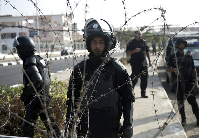 Egyptian riot police gather outside the police academy in Cairo during the trial of deposed Islamist president Mohamed Morsi on November 4, 2013. (AFP Photo / Khaled Desouki)
