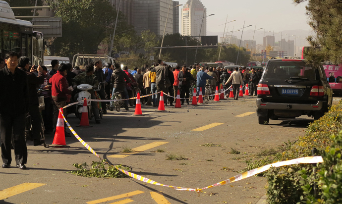 People stand on a street after an explosion outside a provincial headquarters of China's ruling Communist Party in Taiyuan, north China's Shanxi province on November 6, 2013. (AFP/China Out)