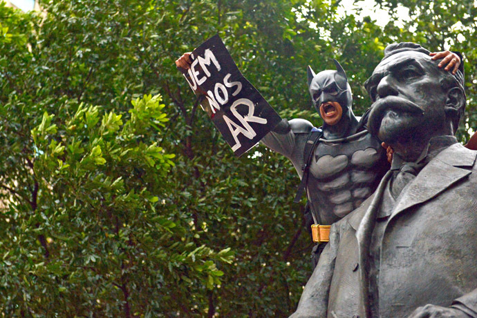 A man disguised as super hero Batman takes part in a demonstration for the Guy Fawkes World Day in Rio de Janeiro, Brazil on November 5, 2013. (AFP Photo/Christophe Simon)