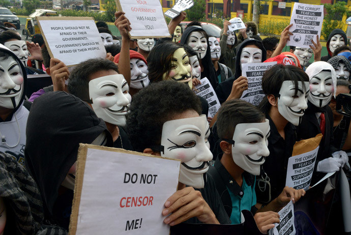 Protesters wearing Guy Fawkes masks display placards during a rally outside the House of Representatives in suburban Quezon city, north of Manila on November 5, 2013. (AFP Photo/Jay Directo)