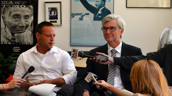 David Hicks (L), once dubbed the "Aussie Taliban" after being captured in Afghanistan and spending more than five years at Guantanamo Bay, talks to the media along with his lawyer Stephen Kenny (C) during a press conference in Sydney on November 6, 2013. (AFP Photo/Saeed Khan)