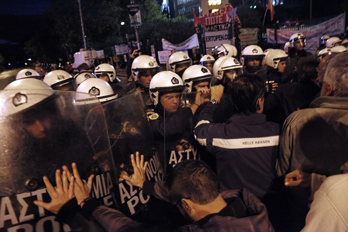 Riot police clash with people gathered outside the headquarters of former public broadcaster ERT in Athens on November 7, 2013. (AFP Photo/Kostis Ntantamis)