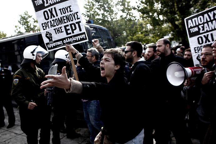 A demonstrator shouts at riot police on November 7, 2013 outside the headquarters of former public broadcaster ERT in Athens. (AFP Photo/Louisa Gouliamaki)