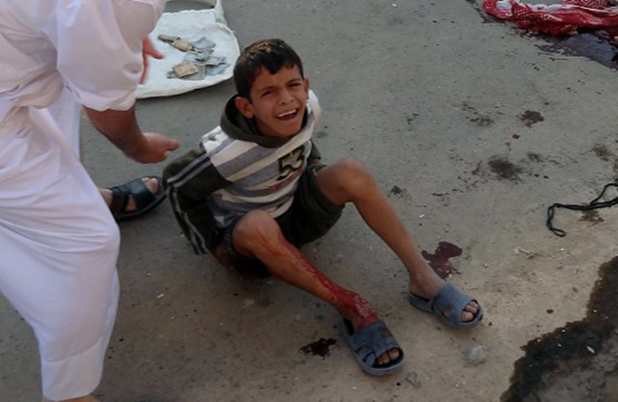 An Iraqi boy cries at the scene of a car bomb attack after it exploded as worshippers left a Sunni mosque after prayers marking the start of the Eid al-Adha Muslim holiday in the northern Iraqi city of Kirkuk on October 15, 2013. (AFP Photo / Marwan Ibrahim)