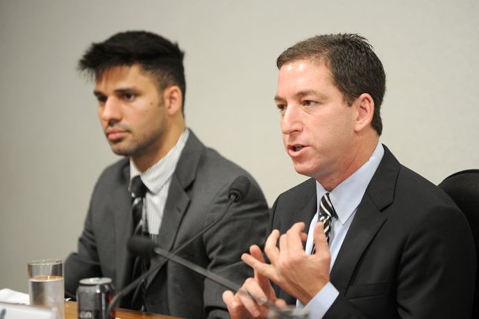 The Guardian's Brazil-based reporter Glenn Greenwald (R), who was among the first to reveal Washington's vast electronic surveillance program, accompanied by his partner David Miranda (AFP Photo)