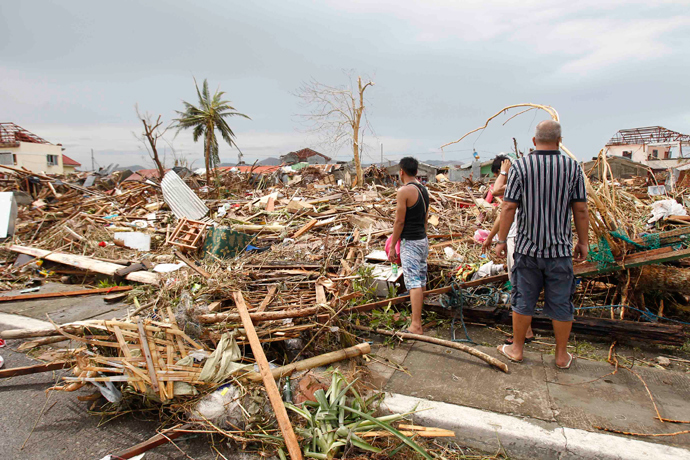 Survivors assess the damage after super Typhoon Haiyan battered Tacloban city, central Philippines November 9, 2013 (Reuters)