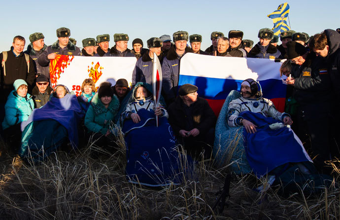 The International Space Station (ISS) crew of U.S. astronaut Karen Nyberg (L), Russian cosmonaut Fyodor Yurchikhin (C) and Italian astronaut Luca Parmitano rests after landing in a remote area near the town of Zhezkazgan in central Kazakhstan November 11, 2013.(Reuters / Shamil Zhumatov)