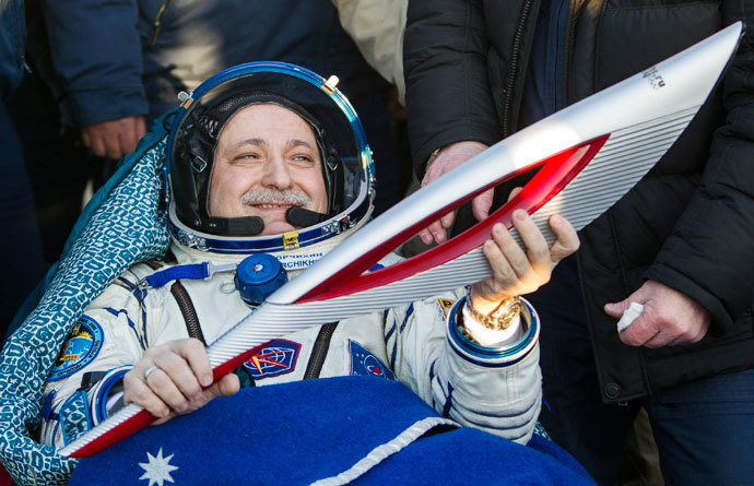 International Space Station (ISS) crew member Russian cosmonaut Fyodor Yurchikhin holds the torch of the 2014 Sochi Winter Olympic Games after landing near the town of Zhezkazgan in central Kazakhstan November 11, 2013. (Reuters / Shamil Zhumatov)