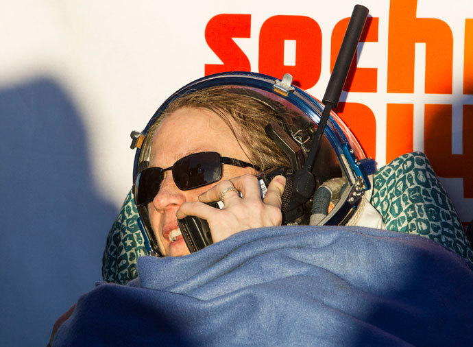 The International Space Station (ISS) crew member of U.S. astronaut Karen Nyberg speaks on a satellite phone after landing in a remote area near the town of Zhezkazgan in central Kazakhstan November 11, 2013.(Reuters / Shamil Zhumatov)